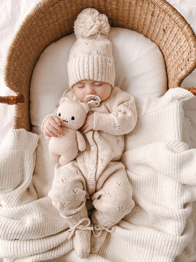 Baby wearing the Classic Knit Romper Petal by Ziggy Lou