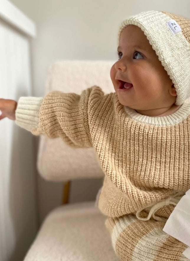 Baby wearing the Jumper Two Tone Wheat by Ziggy Lou