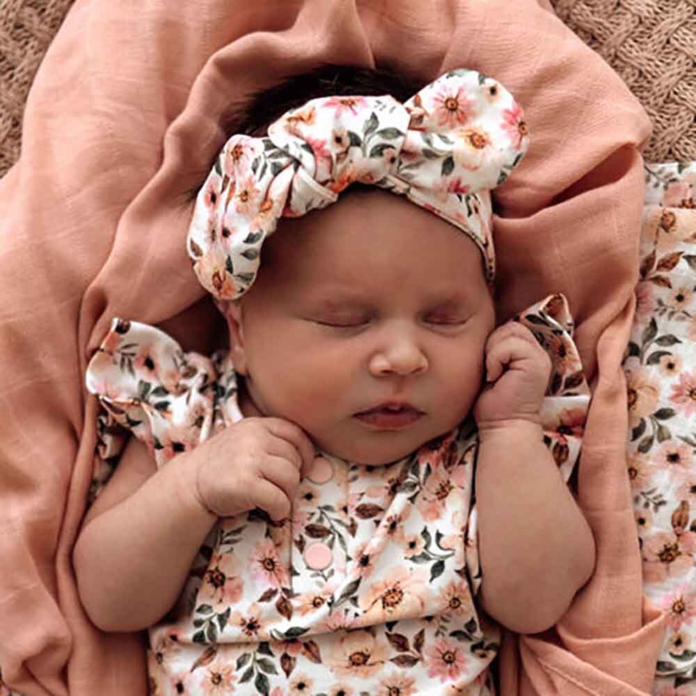 Baby wearing the Spring Floral Topknot by Snuggle Hunny