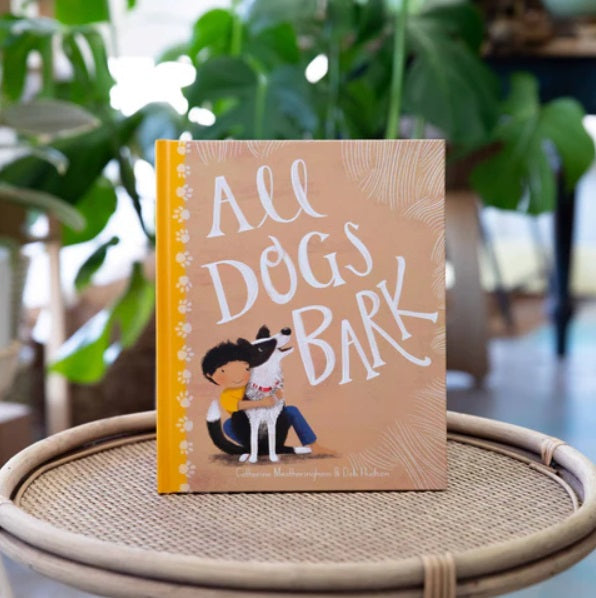 The All Dogs Bark by Windy Hollow Books sitting on a table