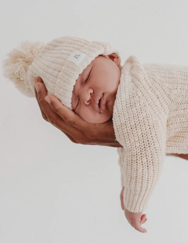 Baby asleep in persons hand wearing Beanie Honey by Ziggy Lou