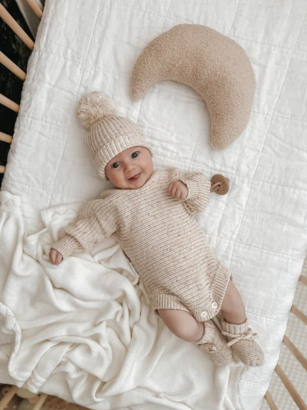 Baby laying down wearing the Beanie Oatmeal Fleck by Ziggy Lou