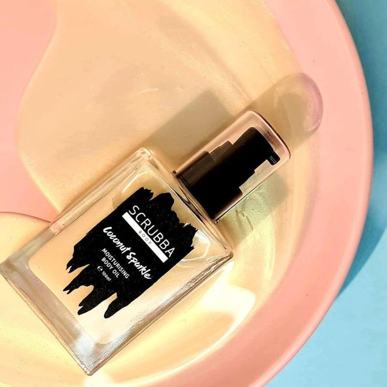 Flatlay of the Coconut Sparkle Body Oil by Scrubba Body