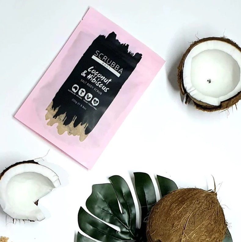 Flat lay of the Coconut & Hibiscus Salt Body Scrub by Scrubba Body