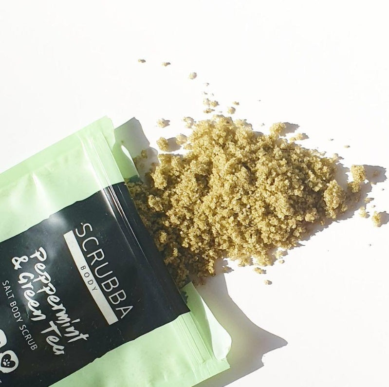 Flat lay of the Peppermint & Green Tea Salt Body Scrub by Scrubba Body