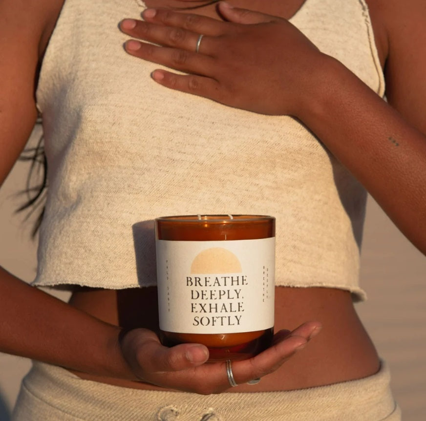 Person holding the Etikette Breathe Deeply Candle - Palo Santo