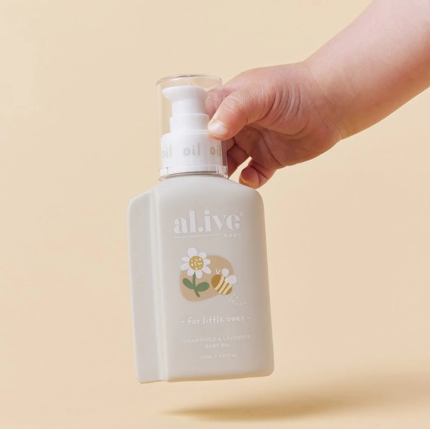 Baby holding the Alive BABY OIL- CHAMOMILE & LAVENDER