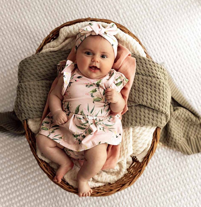 Baby in basket wearing the Cockatoo Organic Dress - Snuggle Hunny