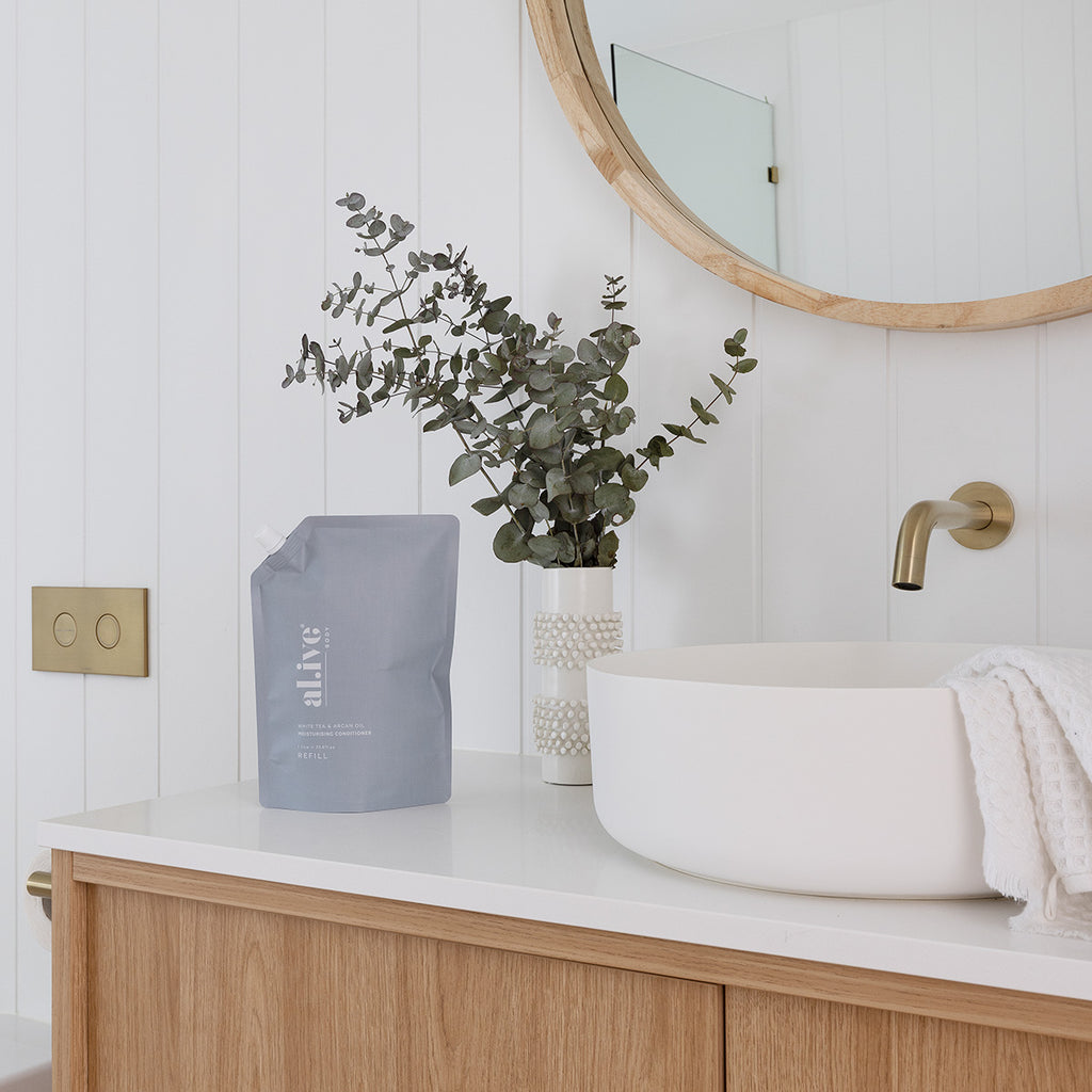 Styled bathroom with the Alive CONDITIONER REFILL - WHITE TEA & ARGAN OIL on the bench