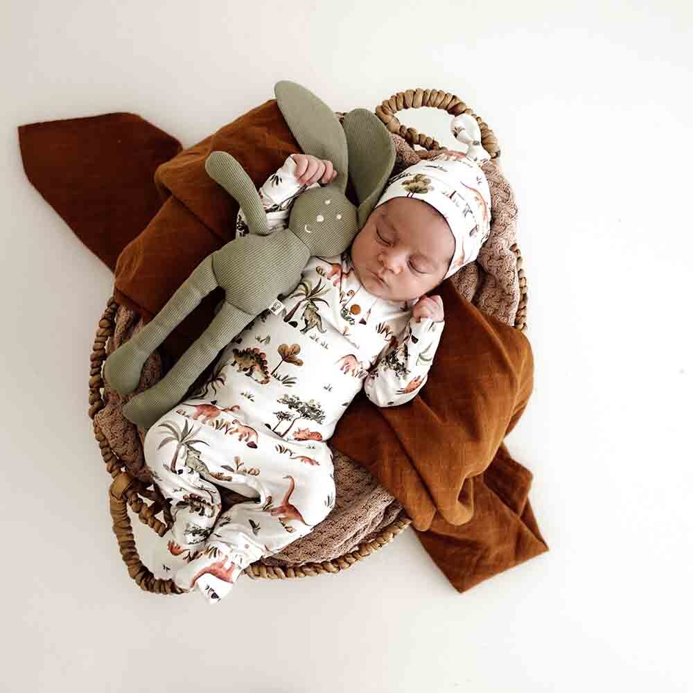 Baby sleeping wearing the dino organic growsuit by snuggle hunny