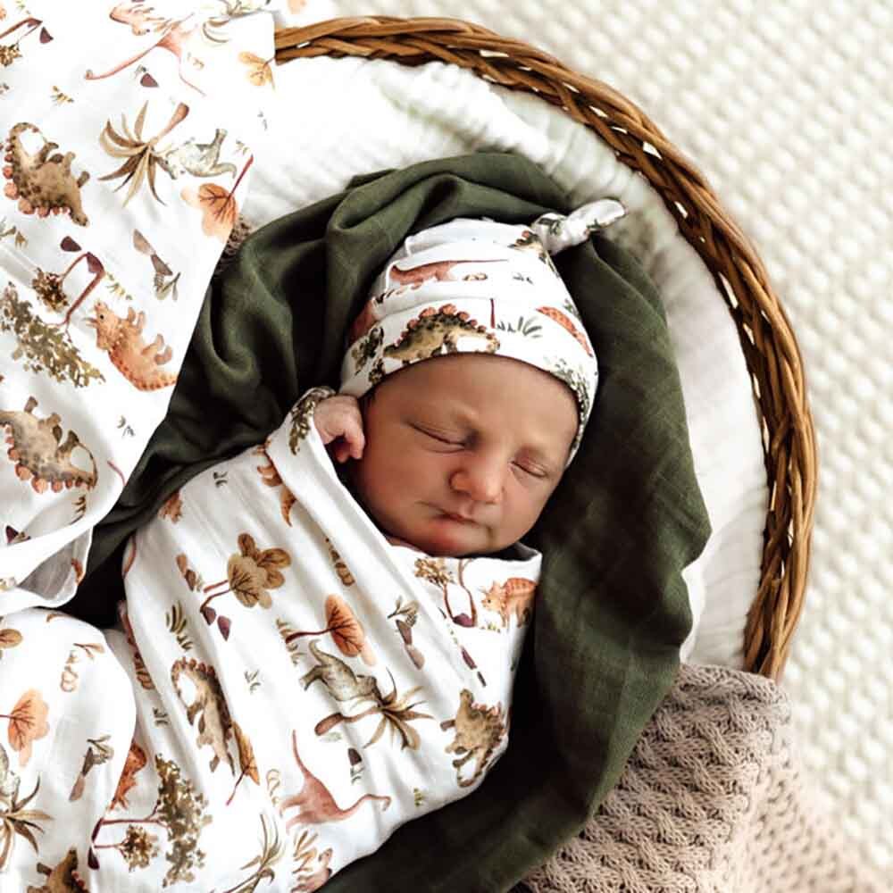 Baby wearing the Dino Organic Knotted Beanie by Snuggle Hunny