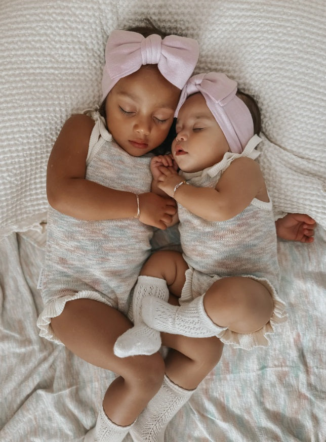 Baby and toddler asleep wearing the Frill Bodysuit Sprinkle by Ziggy