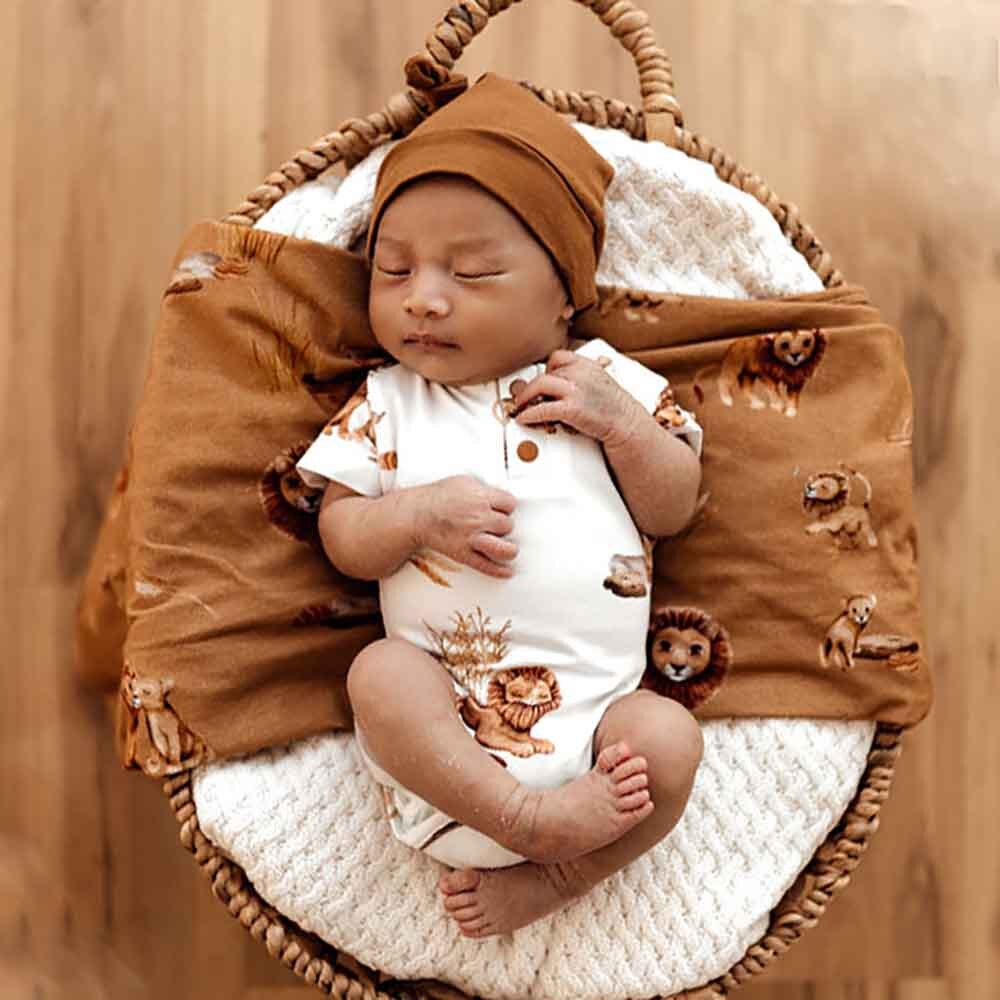 Baby in basket sleeping wearing Lion Short Sleeve Organic Bodysuit