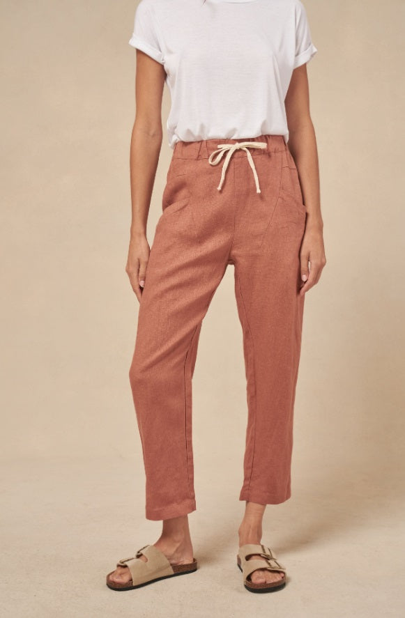 Model wearing the Rust Luxe Linen Pants by Little Lies