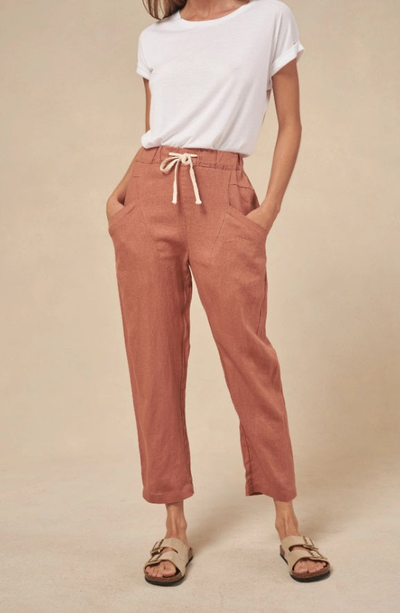 Model wearing the Rust Luxe Linen Pants by Little Lies