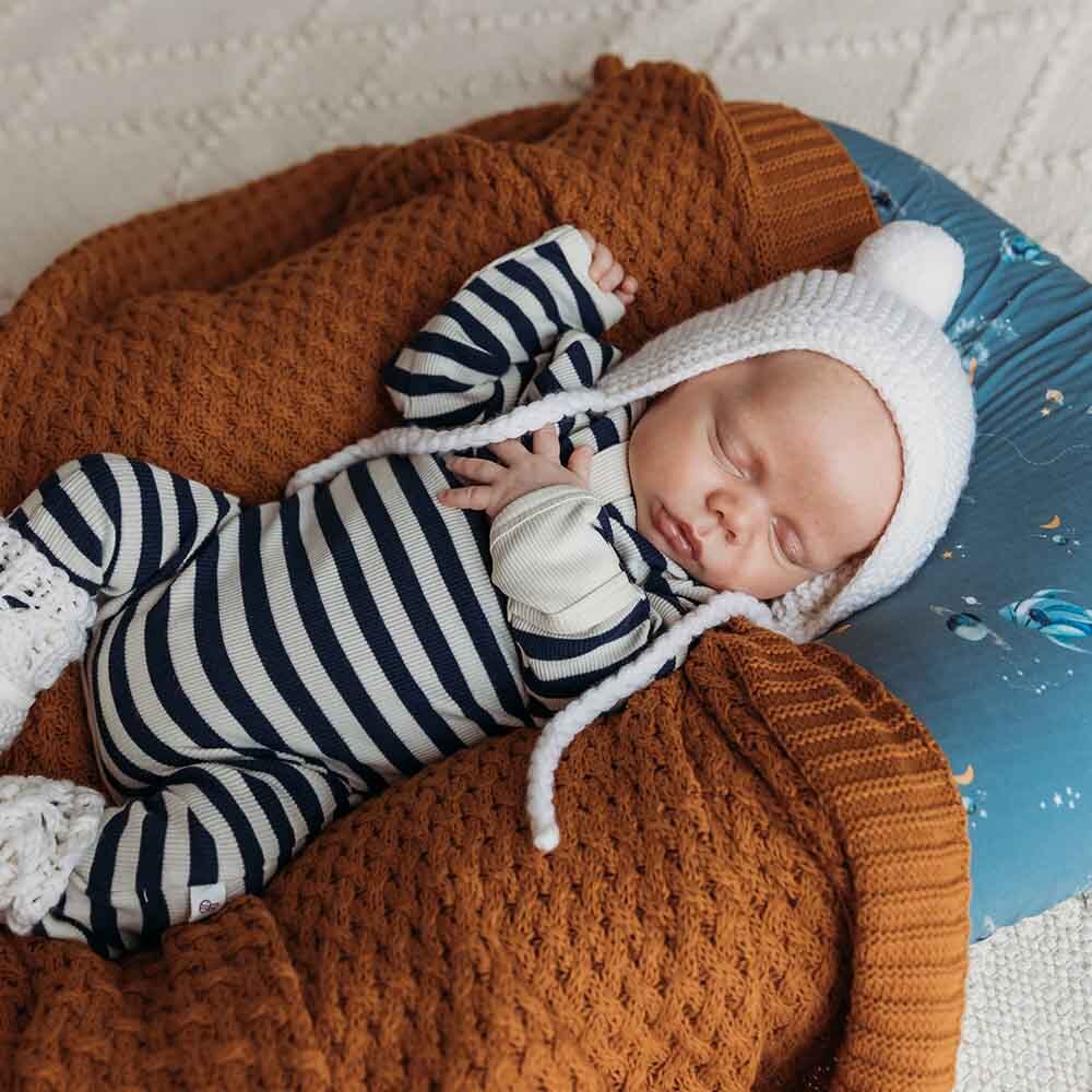 Baby asleep wearing the Moonlight Stripe Organic Growsuit by Snuggle Hunny