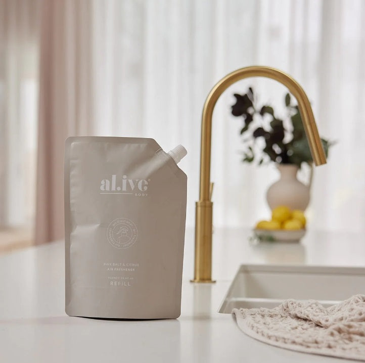 The Alive Body AIR FRESHENER REFILL - PINK SALT & CIRTUS 900ML sitting on a kitchen counter
