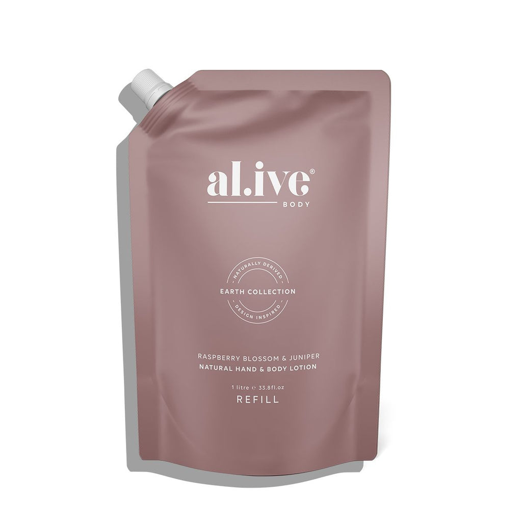 FLATLAY OF THE ALIVE BODY NATURAL HAND AND BODY LOTION IN RASPBERRY BLOSSOM AND JUNIPER