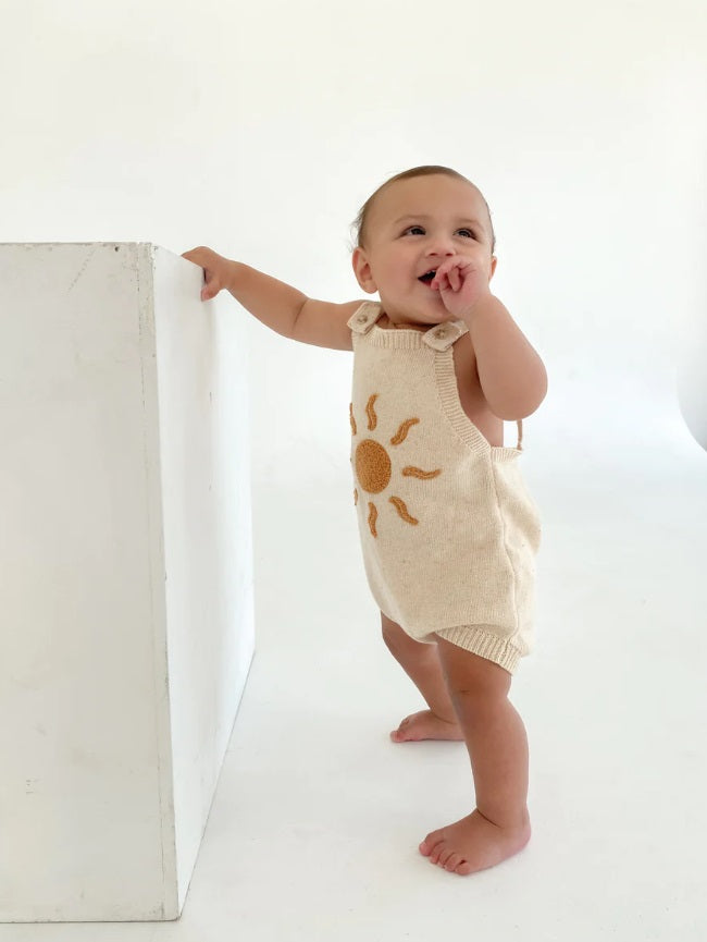 Toddler standing up wearing the Romper Daze by Ziggy