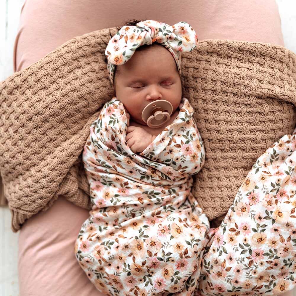 Baby sleeping in the Spring Floral Organic Muslin Wrap by Snuggle Hunny