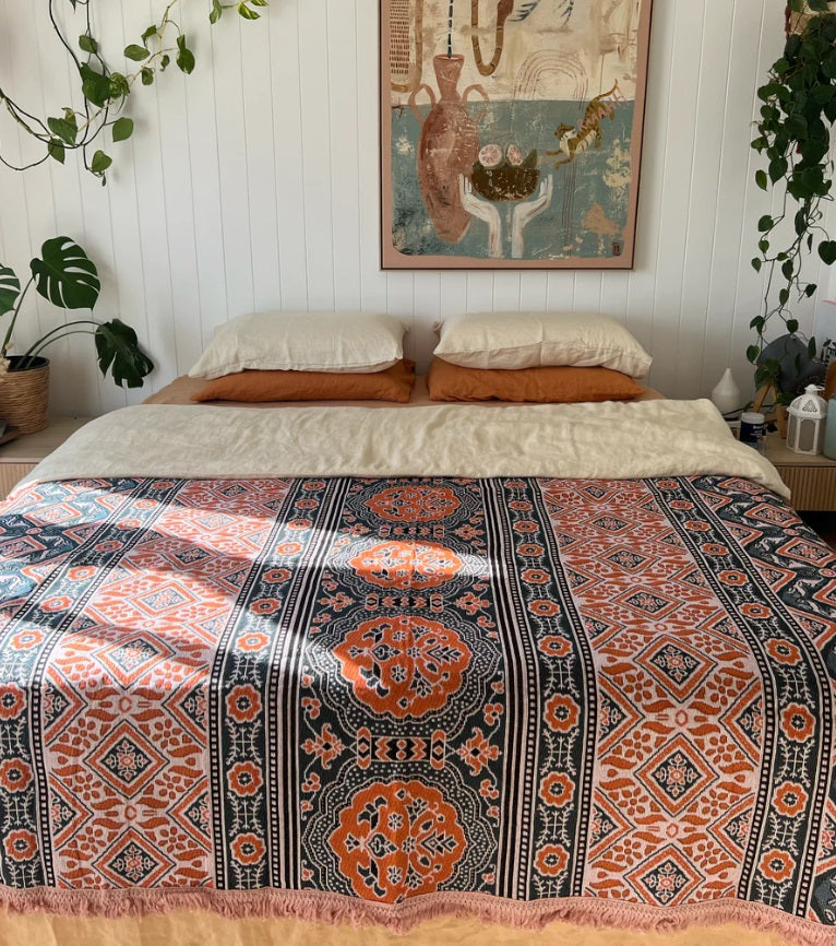 The Poppy Rug by Salty Aura used on a bed
