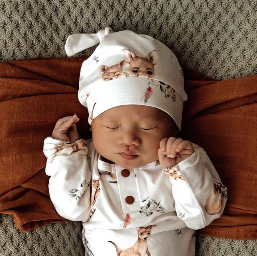 Baby asleep wearing the Kanga Organic Knotted Beanie - Snuggle Hunny